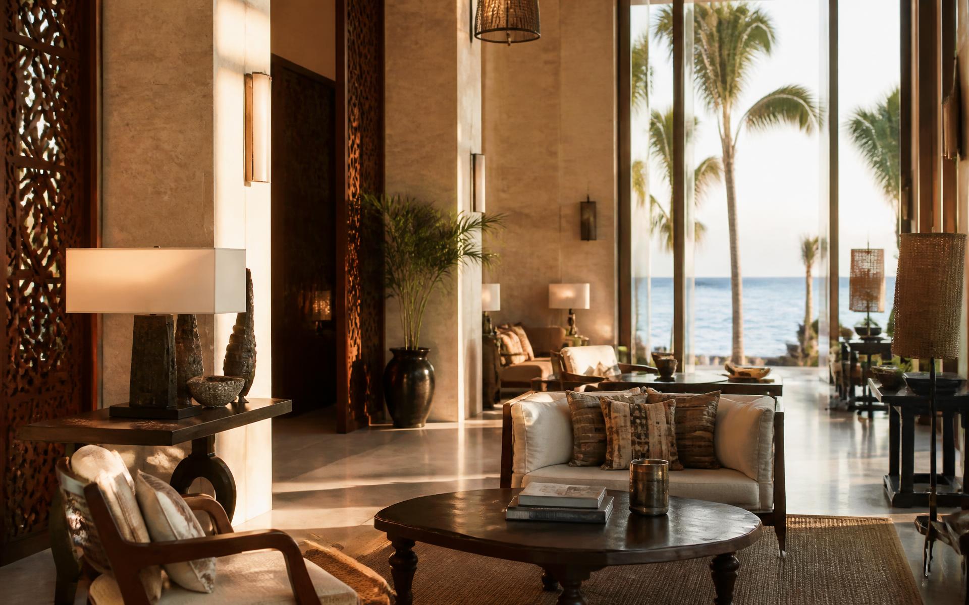 Sunlit coastal hotel lobby overlooking the Indian Ocean
